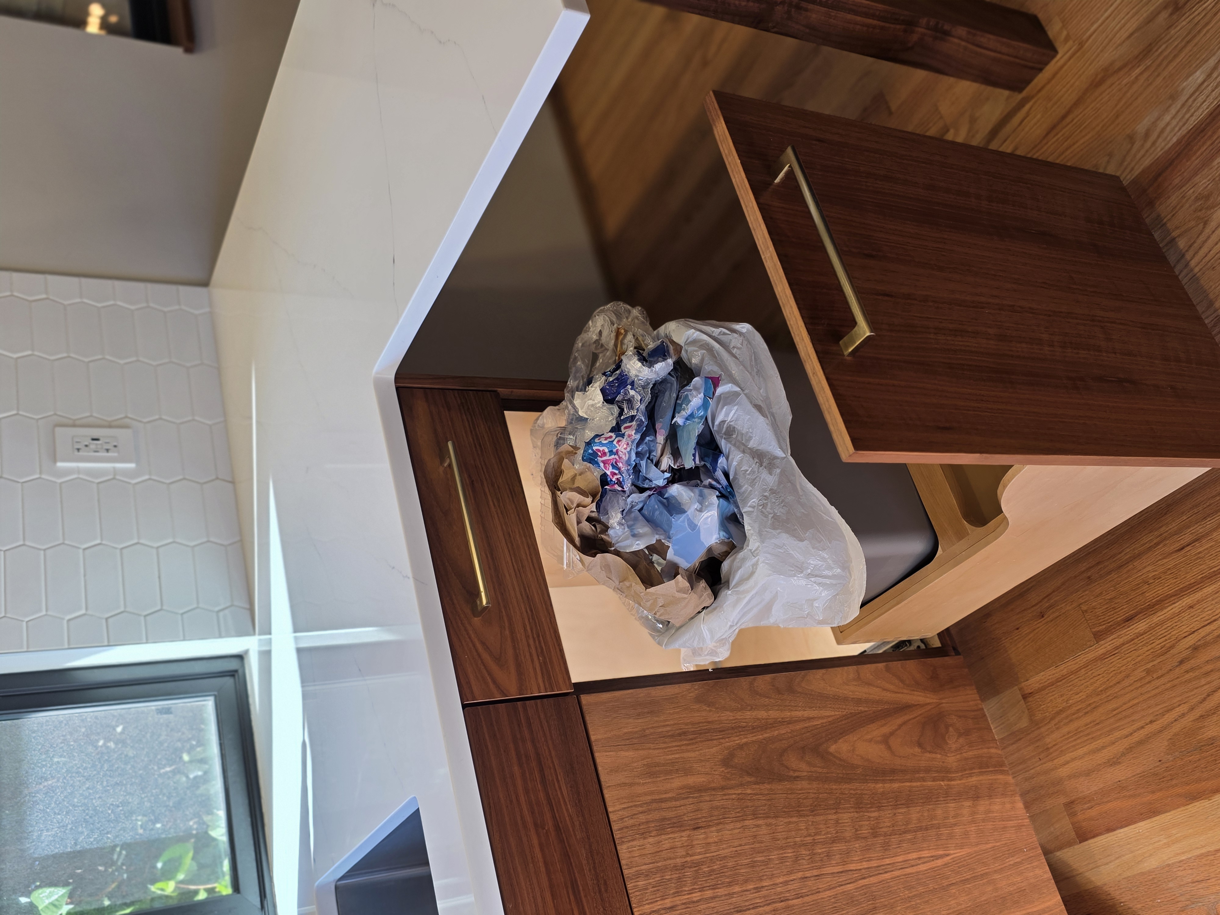 Messy trash can area without Trash Shield, food scraps and spills around the bin